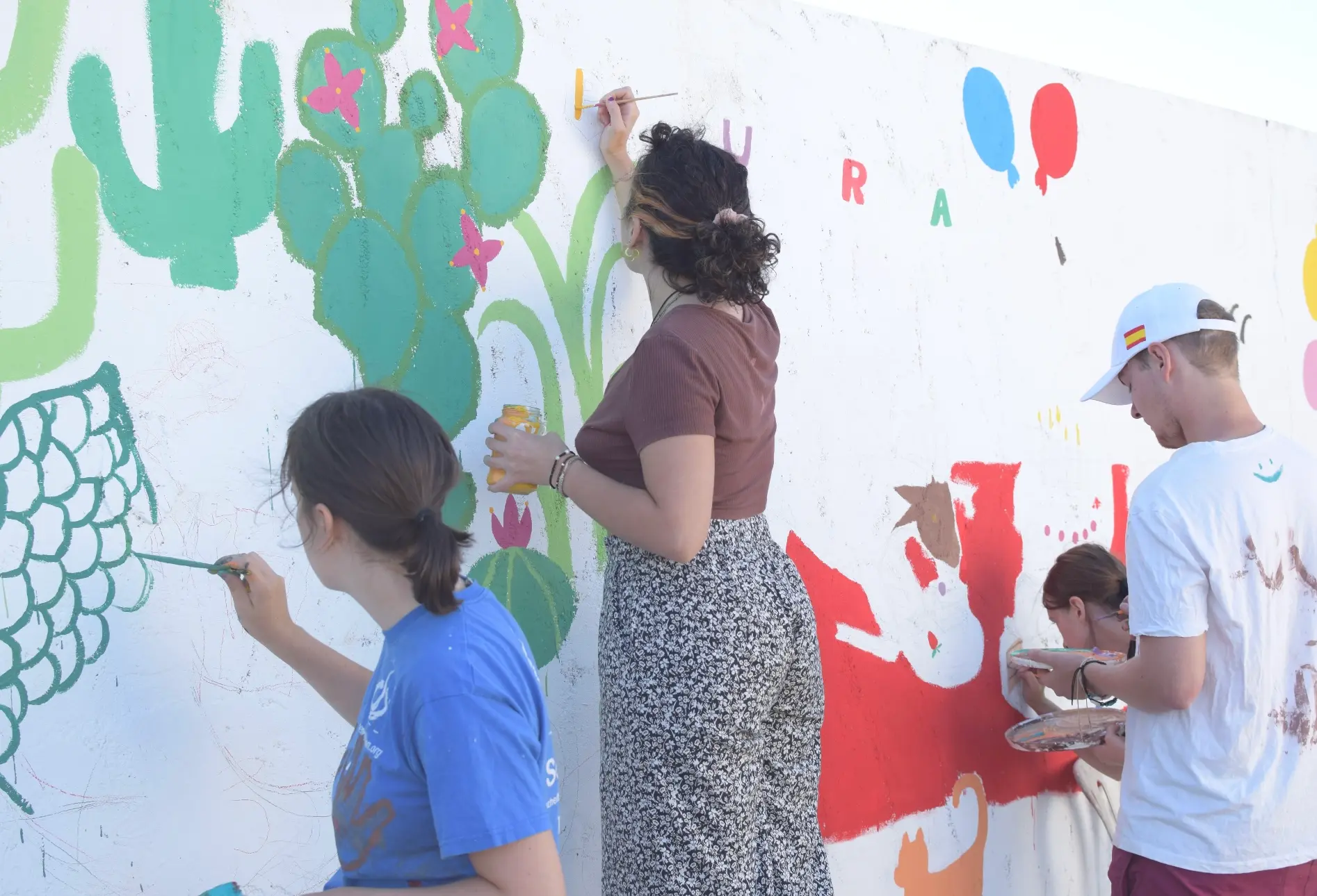 Participants working together on a painting